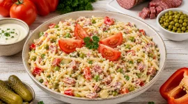 Cremiger Spaghettisalat mit Salami, Erbsen, Paprika und Tomaten.