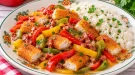Fischstäbchen-Paprika-Topf mit bunten Paprikastreifen, Rauchspeck und Reis.